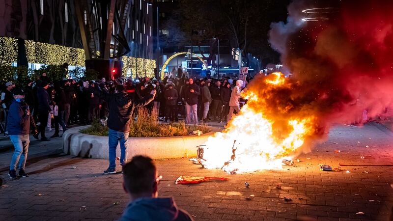 Hundreds of people gather to protest against the tightened coronavirus measures, in Rotterdam, the Netherlands. Photograph: Killian Lindenburg/EPA
