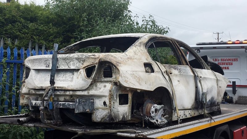 A burned out car which is suspected to have been used as a getaway vehicle in the murder of Mikolaj Wilk. Photograph: Daragh Mc Sweeney/Provision
