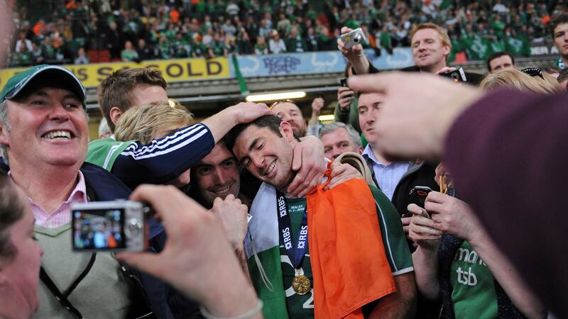 Rob Kearney hugged by family members after Ireland beat Wales 17-15 to win the Grand Slam and Triple Crown. Photograph: Adrian Dennis/AFP