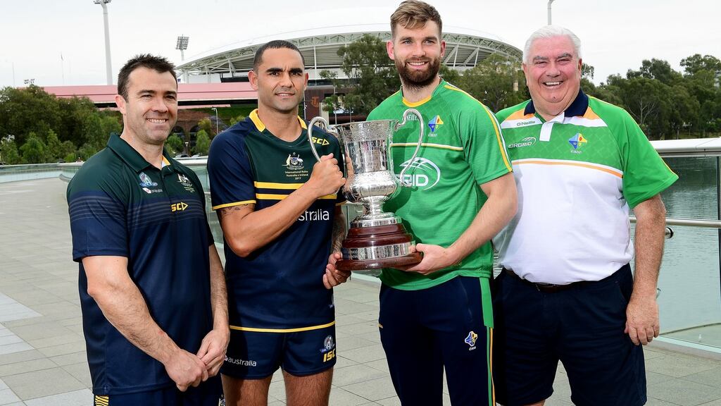 Australian coach Chris Scott, Australian captain Shaun Burgoyne, Ireland’s catain Aidan O’Shea with the Cormac McAnnellen Trophy and Ireland coach Joe Kernan. Photograph: Mark Brake/Getty Images