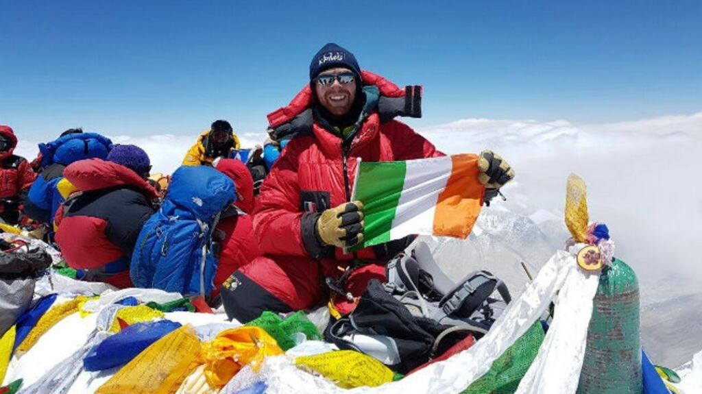 Rob Mortell  holds a tricolour at the top of Everest. Photograph: Rob Mortell/Facebook