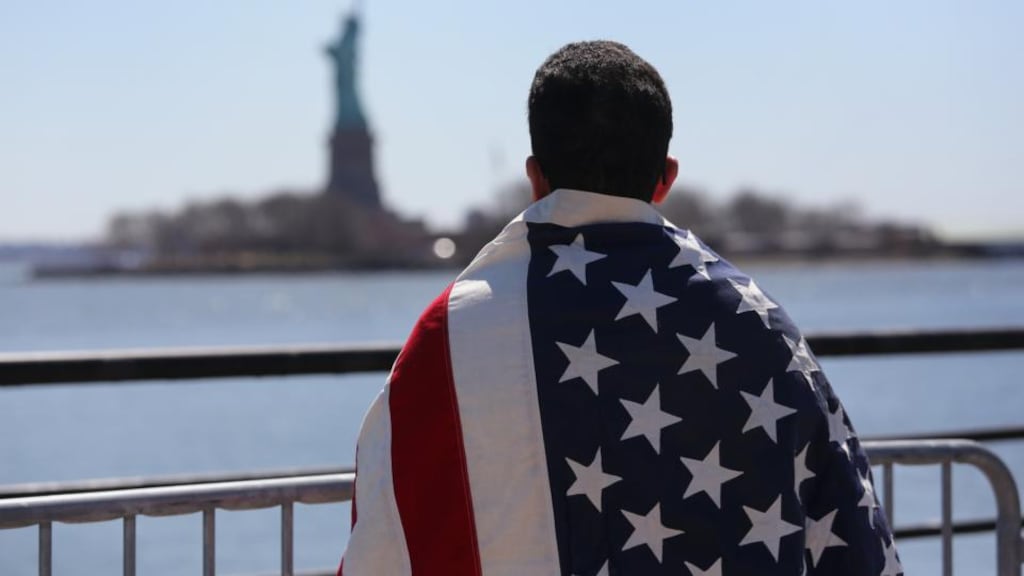 Ecuadorian immigrant Diego Cazar, now living in the US for 12 years, looks towards the Statue of Liberty while participating in a rally for immigration reform at the weekend. Photograph: John Moore Getty Images