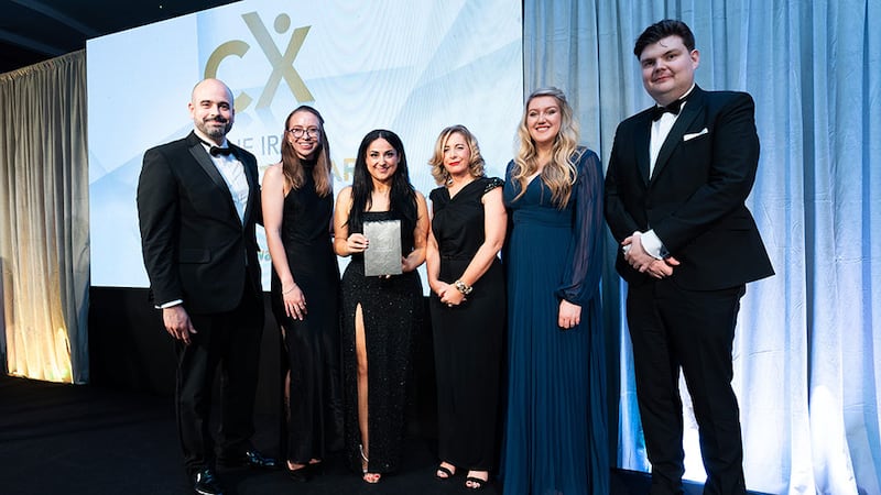 Charlotte Buckley, awards judge, presents the CX impact in professional services award to the Fragomen Ireland team.