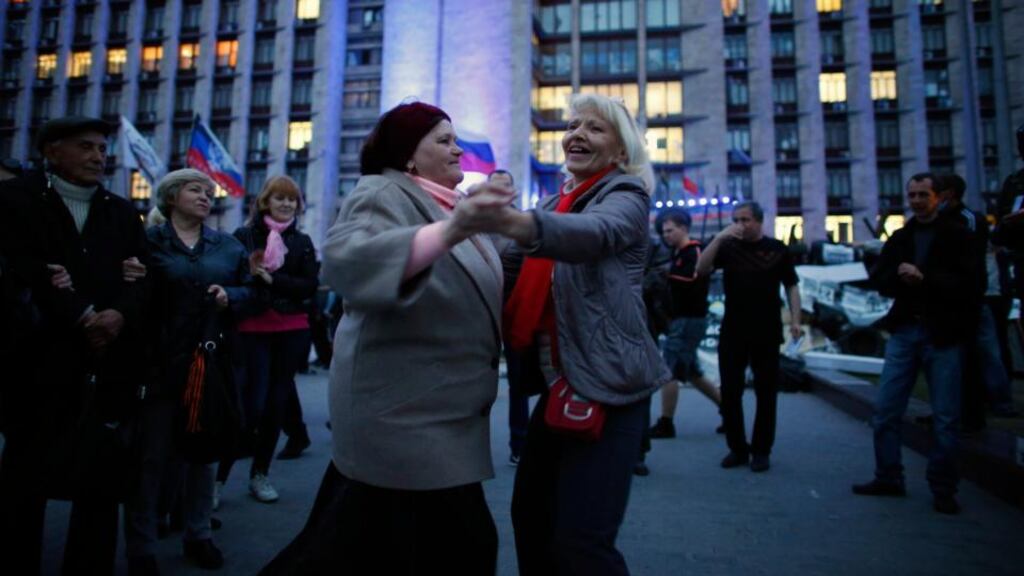 Pro-Russia protesters sing and dance near a barricade outside a regional government building in Donetsk, in eastern Ukraine yesterday. Photograph: Reuters/Marko Djurica