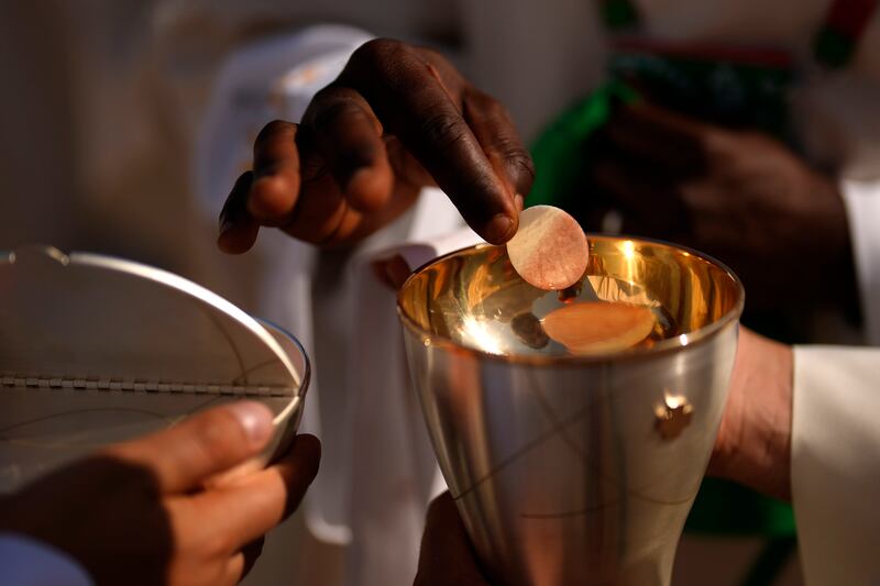 A priest offers communion to a worshipper during Mass presided by Pope Francis in Lisbon. Photograph: Francisco Seco/AP