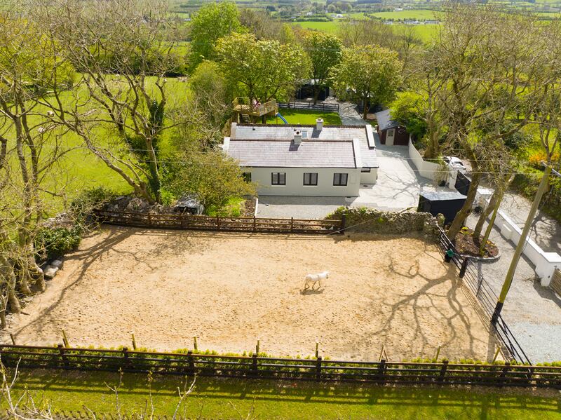The house and, closest to the road, what the owner calls a sandpit for ponies to roam around in.
