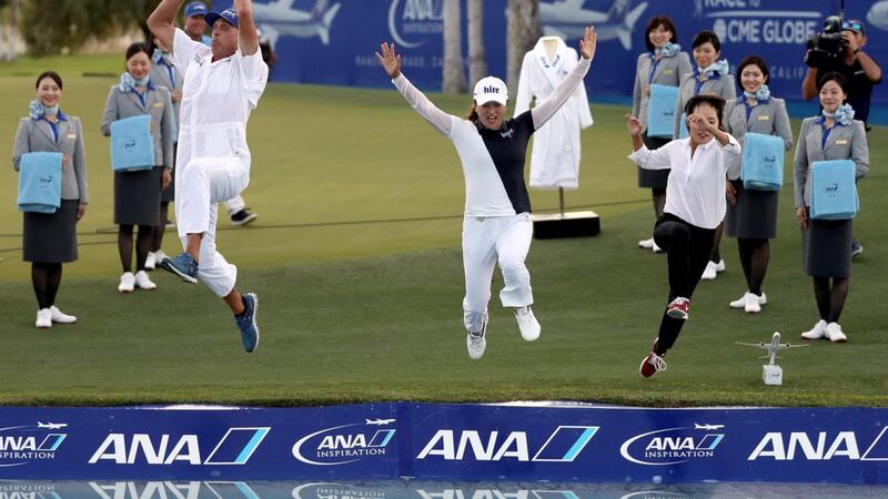 Jin Young Ko, her caddie David Brooker, and her agent Soo jin Choi, leap into Poppie’s Pond next to the 18th green after her win during of the ANA Inspiration at Mission Hills Country Club  in Rancho Mirage, California. Photograph: Matthew Stockman/Getty Images