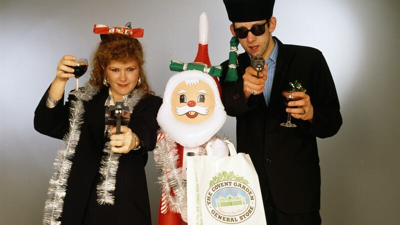 Singers Kirsty MacColl (1959 - 2000) and Shane MacGowan with with toy guns and an inflatable Santa. In 1987, the pair collaborated on the Pogues’ Christmas song Fairytale of New York. Photograph: Tim Roney/Getty Images