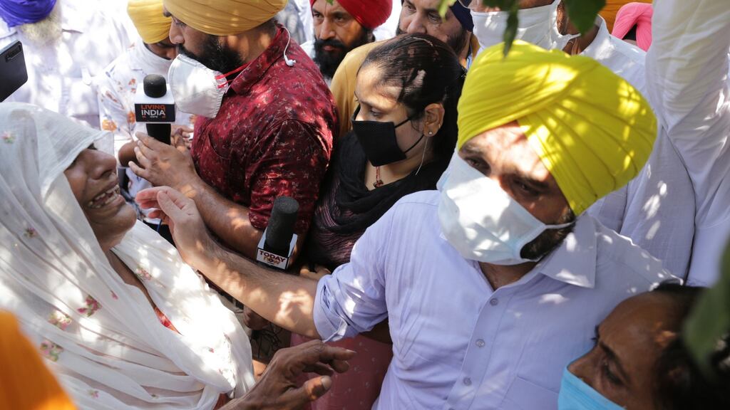 Aam Aadmi Party Punjab unit president Bhagwant Mann (2-R) grieves with the relatives of people who died after consuming tainted liquor, in Tarn Taran, India. Photograph: Raminder Pal Singh/EPA