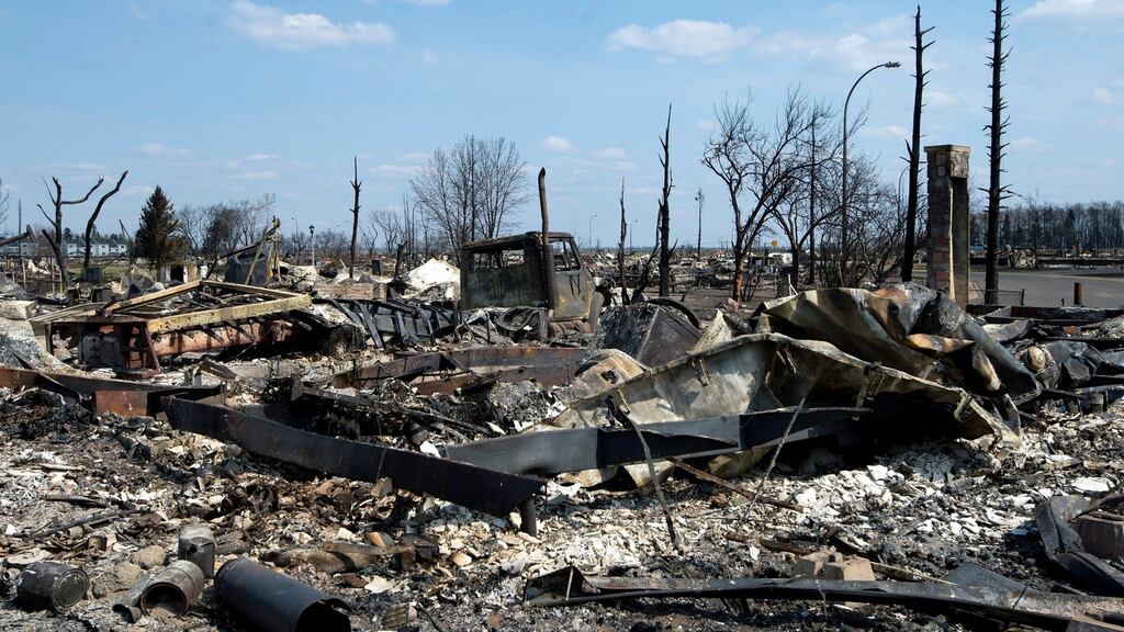 A handout picture made available by the Government of Alberta on 16th May, 2016 shows a general view of damage caused by a wildfire that swept through several neighbourhoods in Fort McMurray on 14th May, 2016. Alberta Health Services has issued an air-quality advisory for the Fort McMurray area. Photograph: Alberta government/EPA