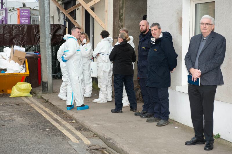 Gardaí and Fr Bill Bermingham after human remains are found following the search of Richatd and Tina Satchwell's home in Youghal, Co Cork. Photograph: Michael Mac Sweeney/Provision