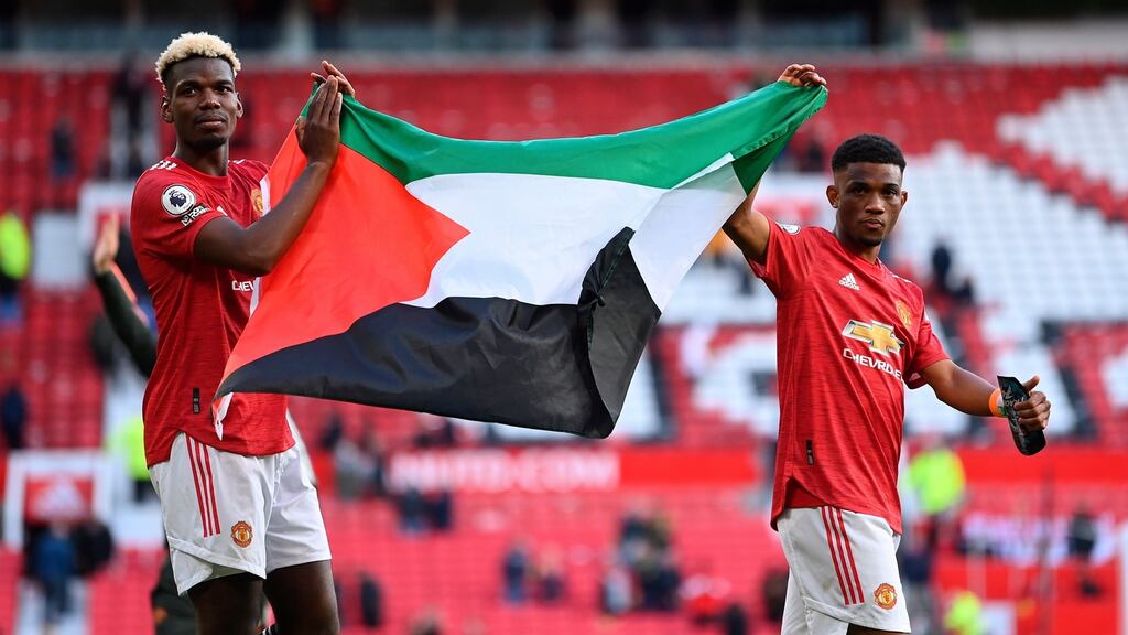 Manchester United’s Paul Pogba and Amad Diallo with a Palestine flag after their team’s draw with Fulham. File photograph: Laurence Griffiths/EPA
