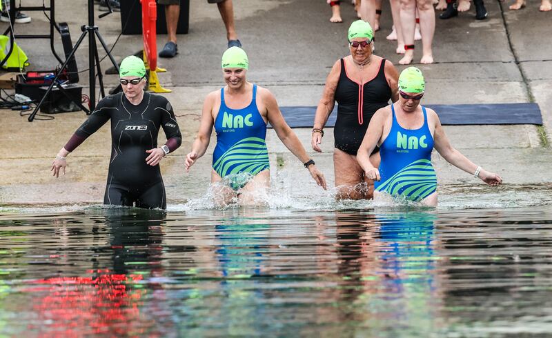The first group of swimmers enter the water.  Photograph: Evan Treacy