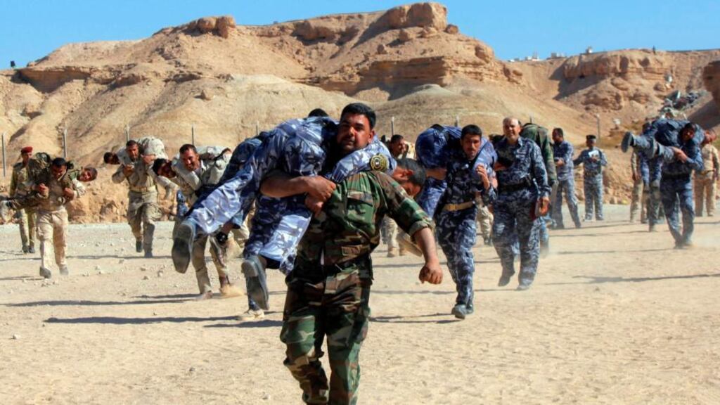 Shia fighters who have joined the Iraqi army to fight against militants of the Islamic Statetake part in field training in the desert in Najaf, south of Baghdad. Photograph: Alaa Al-Marjani/Reuters