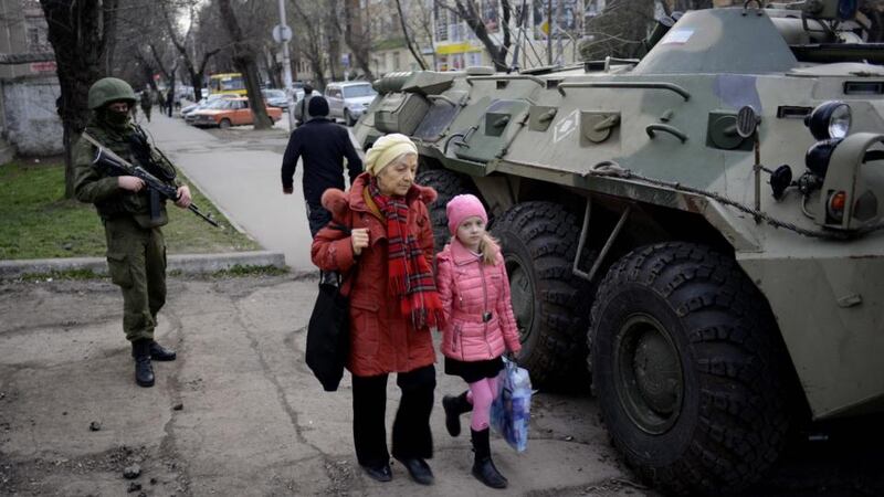 An unmarked soldier stands next to a combat vehicle on a street in Simferopol today. Photograph: Jakub Kaminski/EPA.