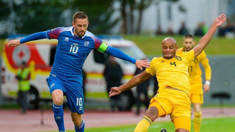 Belgium’s Vincent Kompany challenges Iceland’s Gylfi Thor Sigurdsson during the Nations League match in Reykjavik. Photograph: Haraldur Gudjonsson/AFP/Getty Images