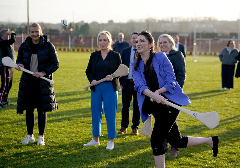 Northern Ireland First Minister Michelle O'Neill (centre), Deputy First Minister Emma Little-Pengelly (right), and Junior Minister Aisling Reilly (left) during a visit to St. Paul's GAA club in west Belfast. Photograph: Niall Carson/PA Wire