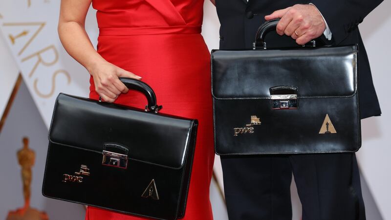 Martha Ruiz (L) and Brian Cullinan of PricewaterhouseCoopers hold briefcases containing the winners on the red carpet. Photograph: Mike Blake/Reuters