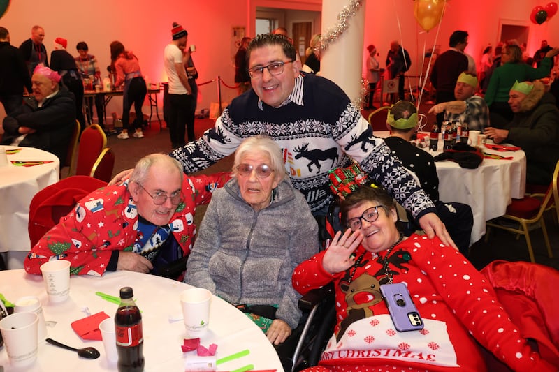 Michael McCabe (behind) with James and Maria Byrne with their mother Kathleen at the Knights of St Columbanus Christmas Day dinner in the RDS. Photograph: Dara Mac Dónaill