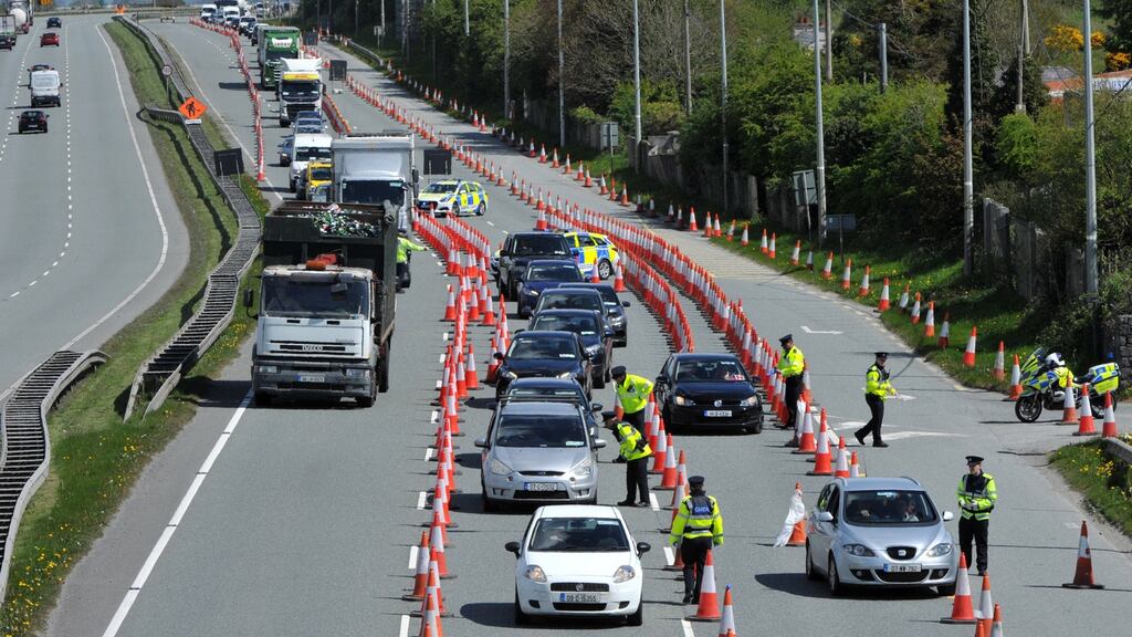 A Garda checkpoint in operation on the N7: The ESRI’s Dr Lunn says that for the vast bulk of people, the regulations are still guiding their daily activities. Photograph: Dara Mac Dónaill