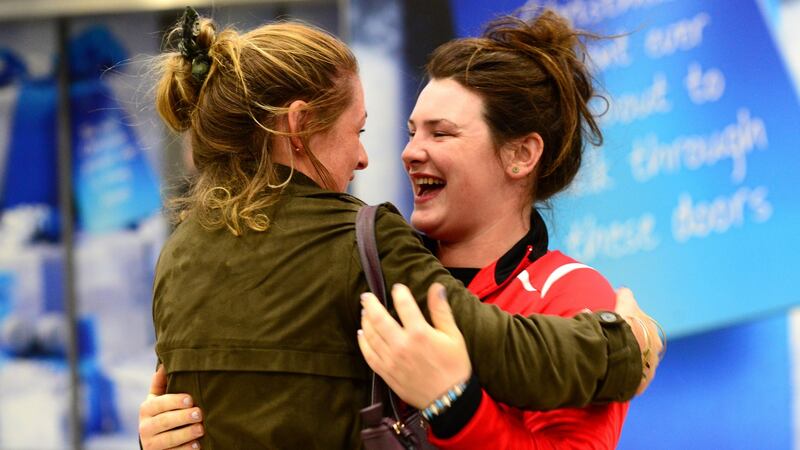 Katie Crawford (left), who came home from Kentucky this morning, with her cousin Amy Creegan at Dublin Airport. Photograph: Cyril Byrne/The Irish Times