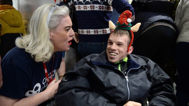 Anne Gough welcomes Igor, part of a group of 30 children and young adults with special needs from the Chernobyl-affected region of Belarus, who are spending Christmas with their host families around the country. Photograph: Dara Mac Dónaill/The Irish Times