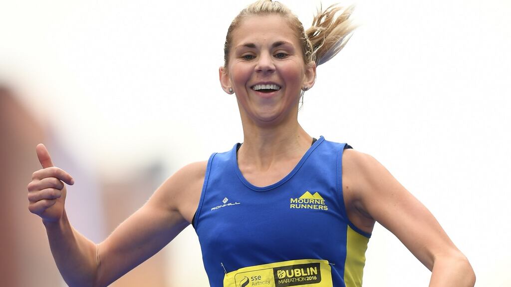 Laura Graham celebrates completing the 2016 Dublin Marathon at Merrion Square in Dublin City. Photograph: Stephen McCarthy/Sportsfile