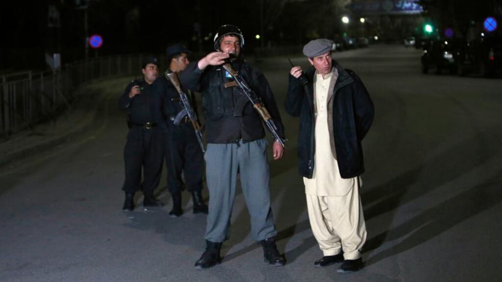 Afghan policemen stand guard near the site of an attack in Kabul in which gunmen fired shots inside the luxury Serena hotel. Photograph: Mohammad Ismail/Reuters.