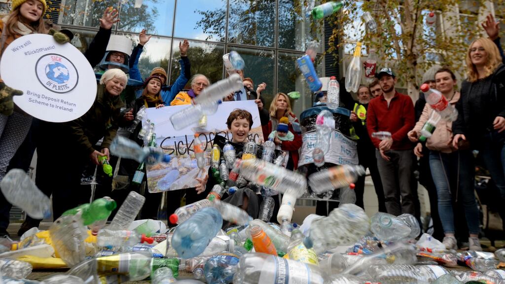 Environmental campaigner Flossie Donnelly, up to her neck in single use plastic during a protest by Sick of Plastic campaigners at the Department of the Environment on Adelaide Road. Photograph: Alan Betson / The Irish Times