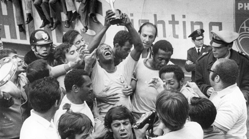 Pele with the trophy after winning the 1970 World Cup in Mexico. Photograph: Getty Images