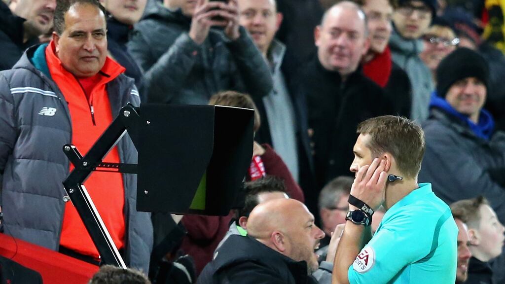 Craig Pawson, match referee, watches the VAR screen before awarding a penalty to Liverpool during The Emirates FA Cup Fourth Round match against West Brom at Anfield. Photograph: Alex Livesey/Getty