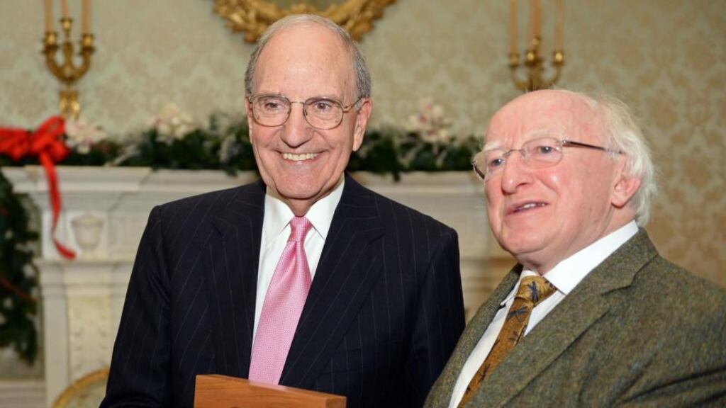 President Michael D Higgins presents former US senator George Mitchell with a Presidential Distinguished Service Award at Áras an Uachtaráin yesterday. Photograph: Eric Luke