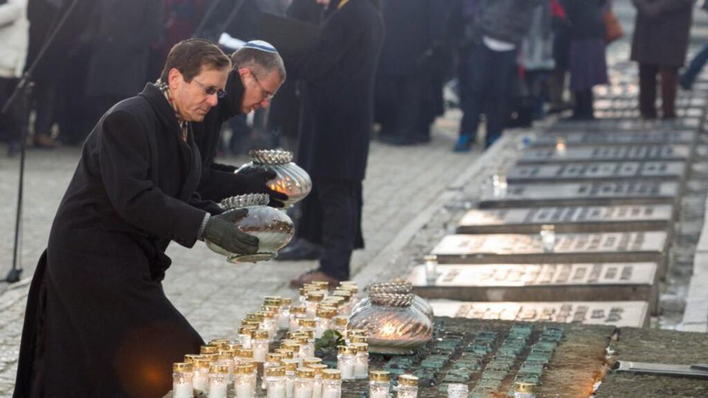 Isaac Herzog (left), the Israeli Knesset leader of the opposition Labor party lights candles at the International Monument to the Victims of Fascism during a ceremony marking the 69th anniversary of the liberation of the Nazi concentration camp in Auschwitz . Photograph: AndrzeJ Grygiel/EPA