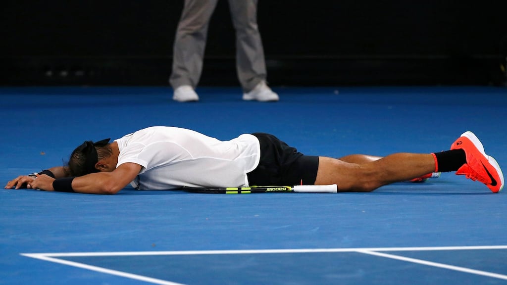Rafael Nadal falls onto the court as he celebrates winning  a sensational men’s singles semi-final  against Bulgaria’s Grigor Dimitrov at the Australian Open in Melbourne. Photograph: Issei Kato/Reuters