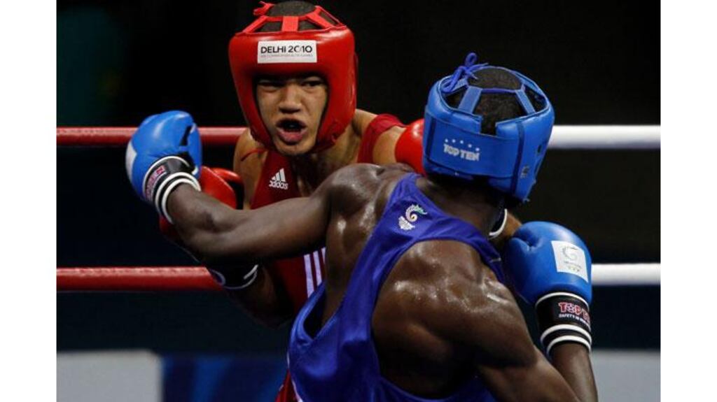 Northern Ireland's Thomas McCarthy (red) lands a punch on Kenya's Joshua Makonjio during their semi-final men's 81kg boxing match at the Commonwealth Games in New Delhi (Amit Dave/Reuters)