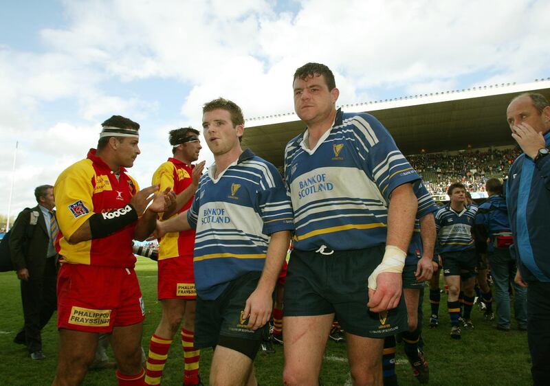 A dejected Gordon D'Arcy and Reggie Corrigan of Leinster after defeat to Perpignan in the European Cup semi-final of 2003. Photograph: Billy Stickland/Inpho