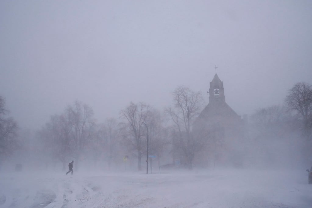 A lone pedestrian makes his way across Colonial Circle in Buffalo, New York. Photograph: Derek Gee/The Buffalo News/AP