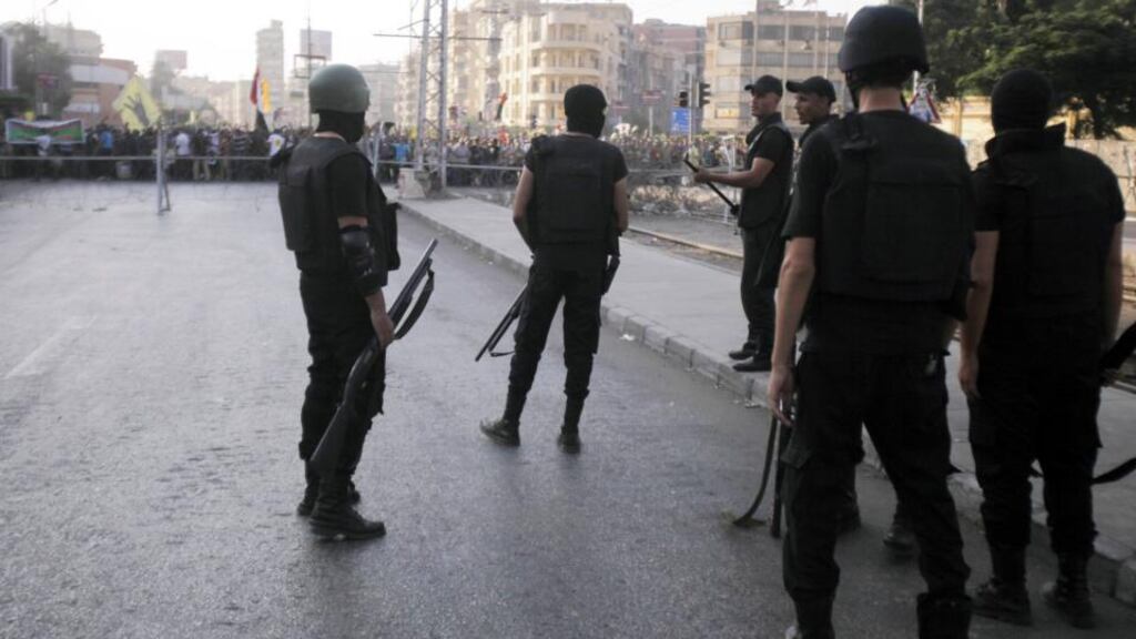 Riot police officers take position during a protest by members of the Muslim Brotherhood and supporters of ousted Egyptian president Mohamed Morsi in front of El-Thadiya presidential palace in Cairo yesterday. Photograph: Reuters/Amr Abdallah Dalsh