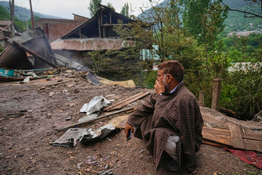 A man sits outside his house which was destroyed by Pakistani shelling in Lagama village in Uri. Photograph: Dar Yasin/AP