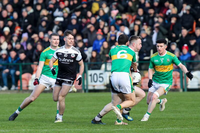 Anthony Morgan of Kilcoo is challenged by Michael Warnock of Glen at the Athletic Grounds in Armagh last Sunday. Photograph: ©INPHO/Declan Roughan