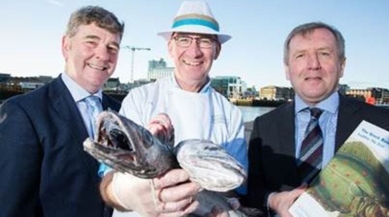 Marine Institute chief executive Peter Heffernan, fishmonger Pat O’Connell and Minister for Marine Michael Creed review the 2018 Marine Institute annual stock book