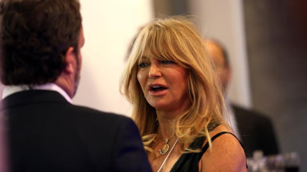 Goldie Hawn speaks to a delegate during a break in sessions on the opening day of the World Economic Forum in Davos, Switzerland, yesterday. The actor is speaking at the forum about the merits of meditation. Photographer: Chris Ratcliffe/Bloomberg