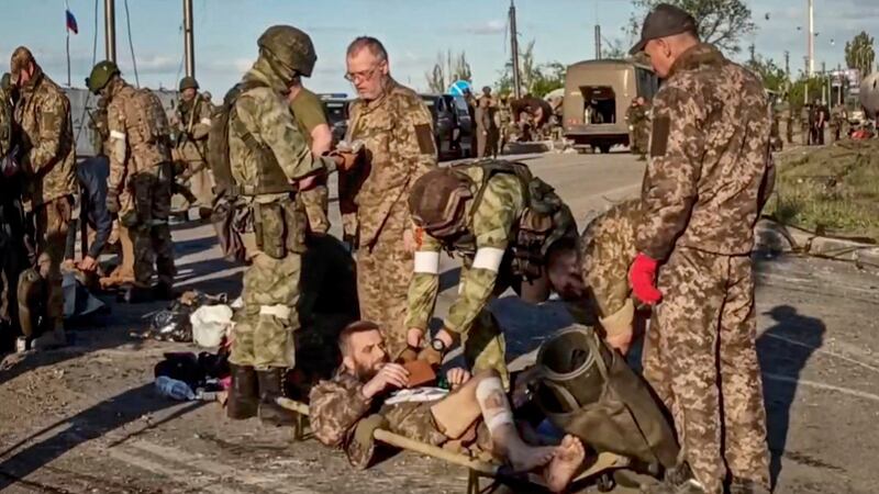 Russian servicemen frisk Ukrainian servicemen as they are  evacuated from the besieged Azovstal steel plant in Mariupol. Photograph: Russian Defence Ministry Press Service Handout/ EPA
