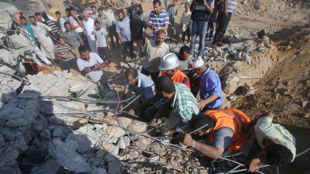 Palestinians search for victims under the rubble of a house which witnesses said was destroyed by an Israeli air strike during an Israeli ground offensive east of Khan Younis in southern Gaza today. Photograph: Ibraheem Abu Mustafa /Reuters