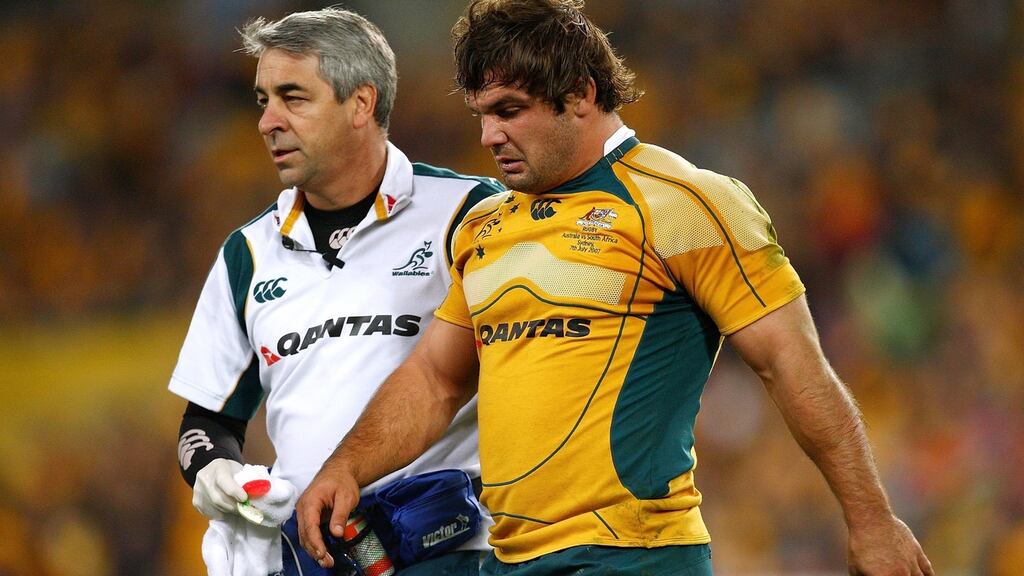 Dr Martin Raftery helps Adam Freier of the Wallabies from the field during the 2007 Tri Nations match against the South African Springboks in Sydney. Photograph: Getty images