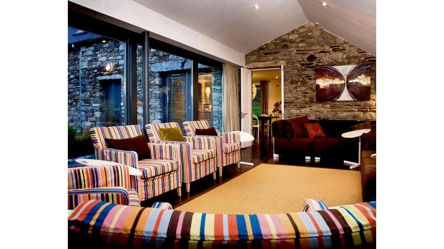 CREATIVE COCOON (clockwise from above left): Pat McCarthy at the entrance to Ballilogue Clochán; the sittingroom; dining room; garden. PHOTOGRAPHS: MARK McCALL