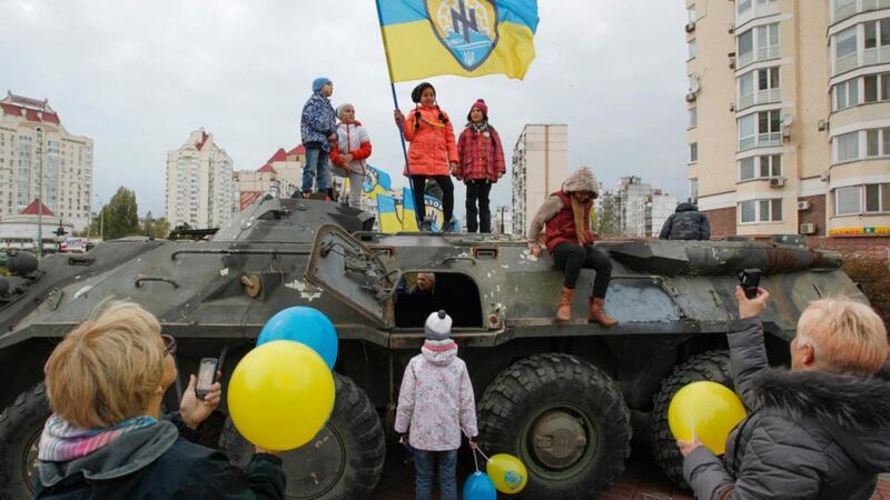 Strange normality: children play on a captured rebel armoured personnel carrier in Kiev. Photograph: Valentyn Ogirenko/Reuters