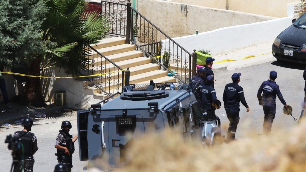 Jordanian emergency services and security forces at a damaged building during a police raid on a house sheltering terrorists suspected of detonating a bomb under a police van. Photograph: Getty Images