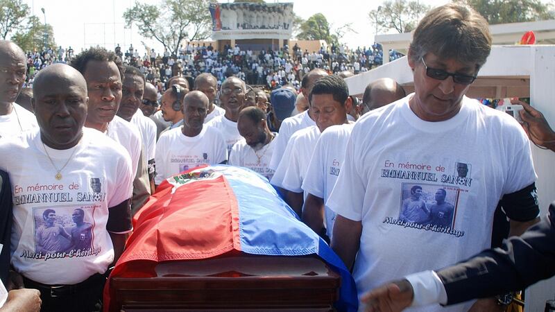 Former Haitian national soccer players Philippe Vorbes (R) and Tom Pouce (L) carry the casket of their teammate Emmanuel Sanon on March 5th, 2008. Photograph: Thony Belizaire/AFP