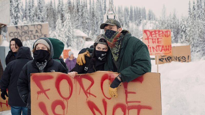 Protesters watch as police dismantle the barricade at the Unist’ot’en camp, near Houston, British Columbia, Canada.  Photograph: Amber Bracken/The New York Times